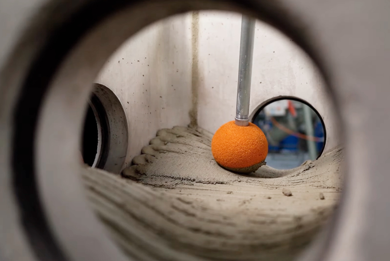 Orange ball on concrete surface viewed through circular frame