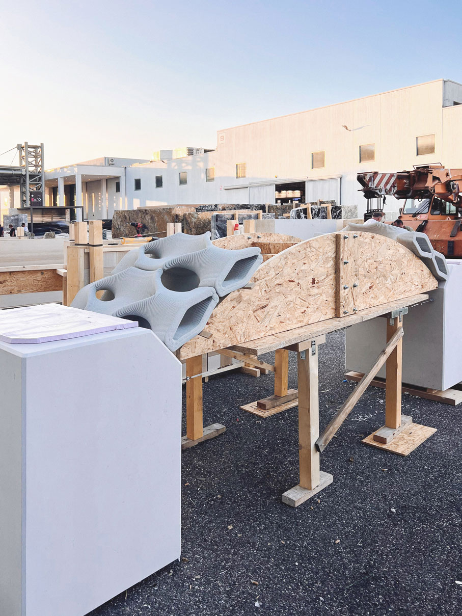 Construction site with curved concrete structures and wooden scaffolding