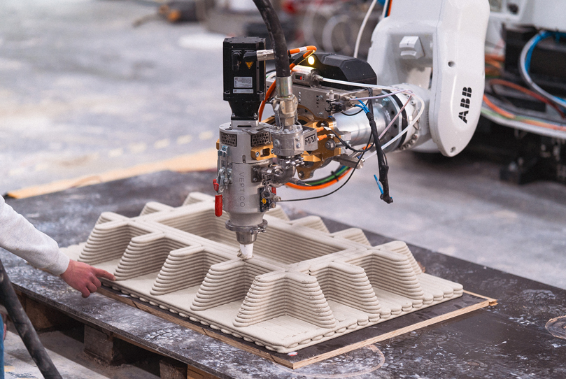 3D concrete printing robot creating layered geometric structures for advanced projects
