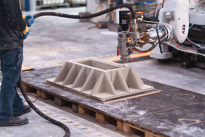 3D concrete printing robot creating geometric architectural project on workshop platform