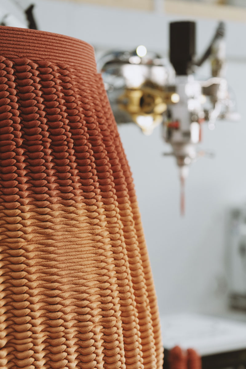 3D concrete printing project with textured terracotta-colored layered object