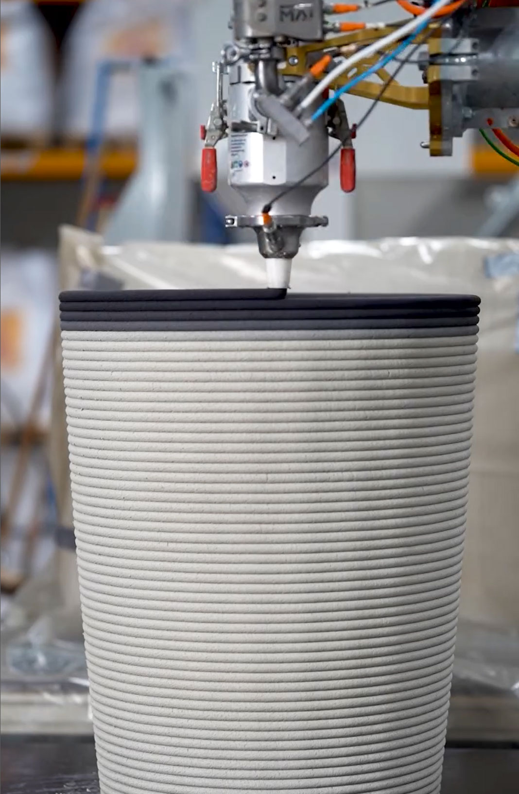 3D concrete printing machine creating layered architectural project prototype