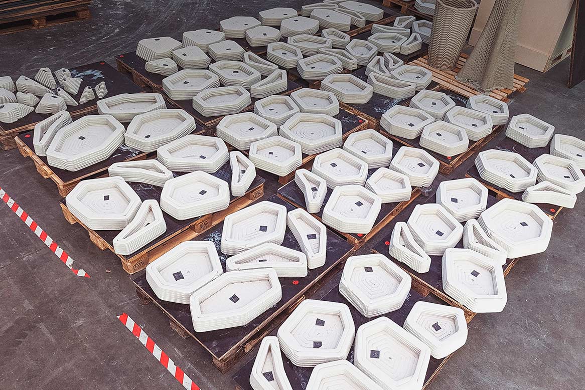 3D concrete printing projects with stacked geometric components on pallets