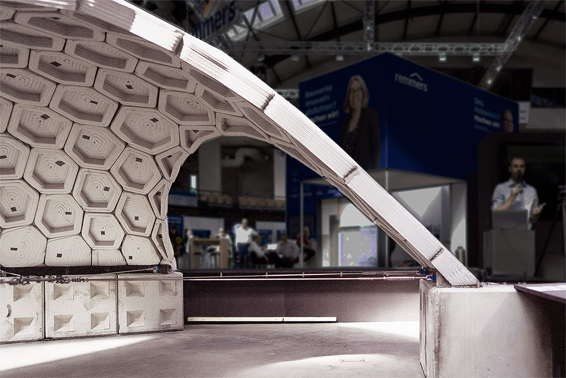 Curved architectural structure with hexagonal panels at technology conference