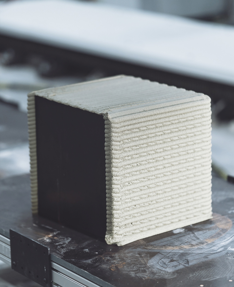 3D concrete printing project creating layered geometric cube prototype