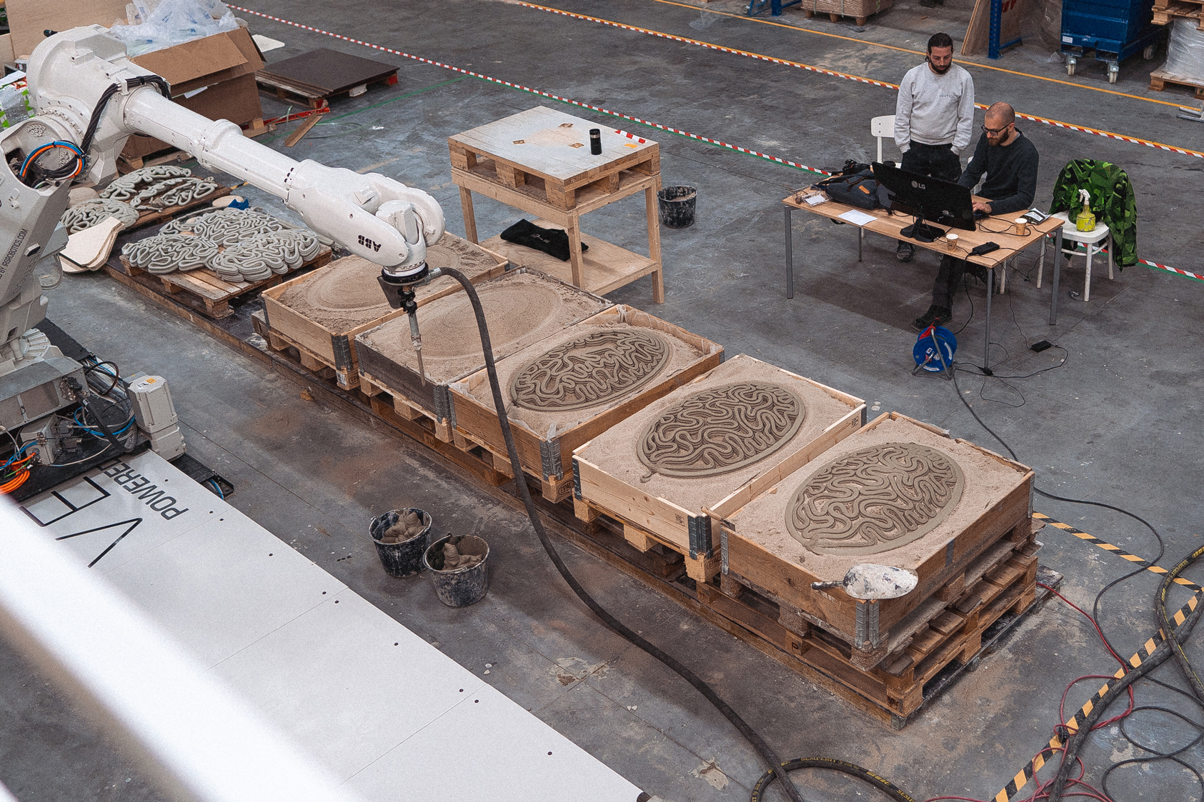 3D concrete printing projects with robotic arm creating intricate designs