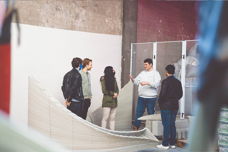 3D concrete printing project team discussing innovative architectural design details