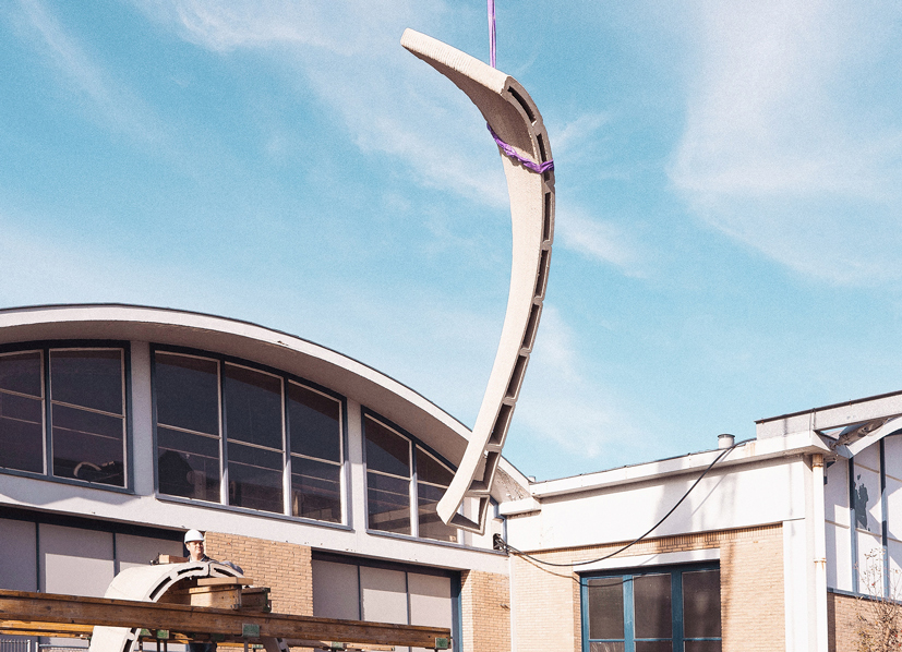 3D concrete printing project creating curved architectural structure on building