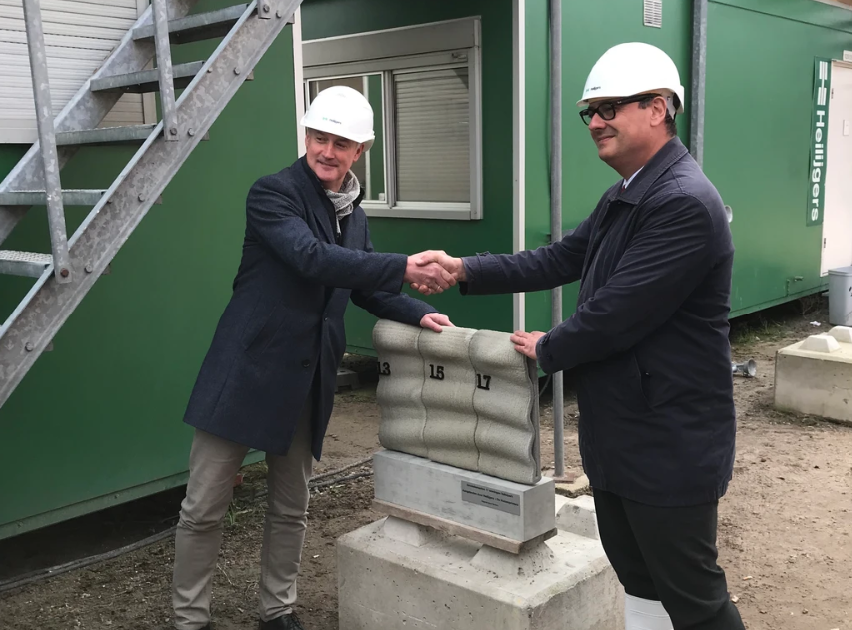 3D concrete printing project managers shaking hands at construction site
