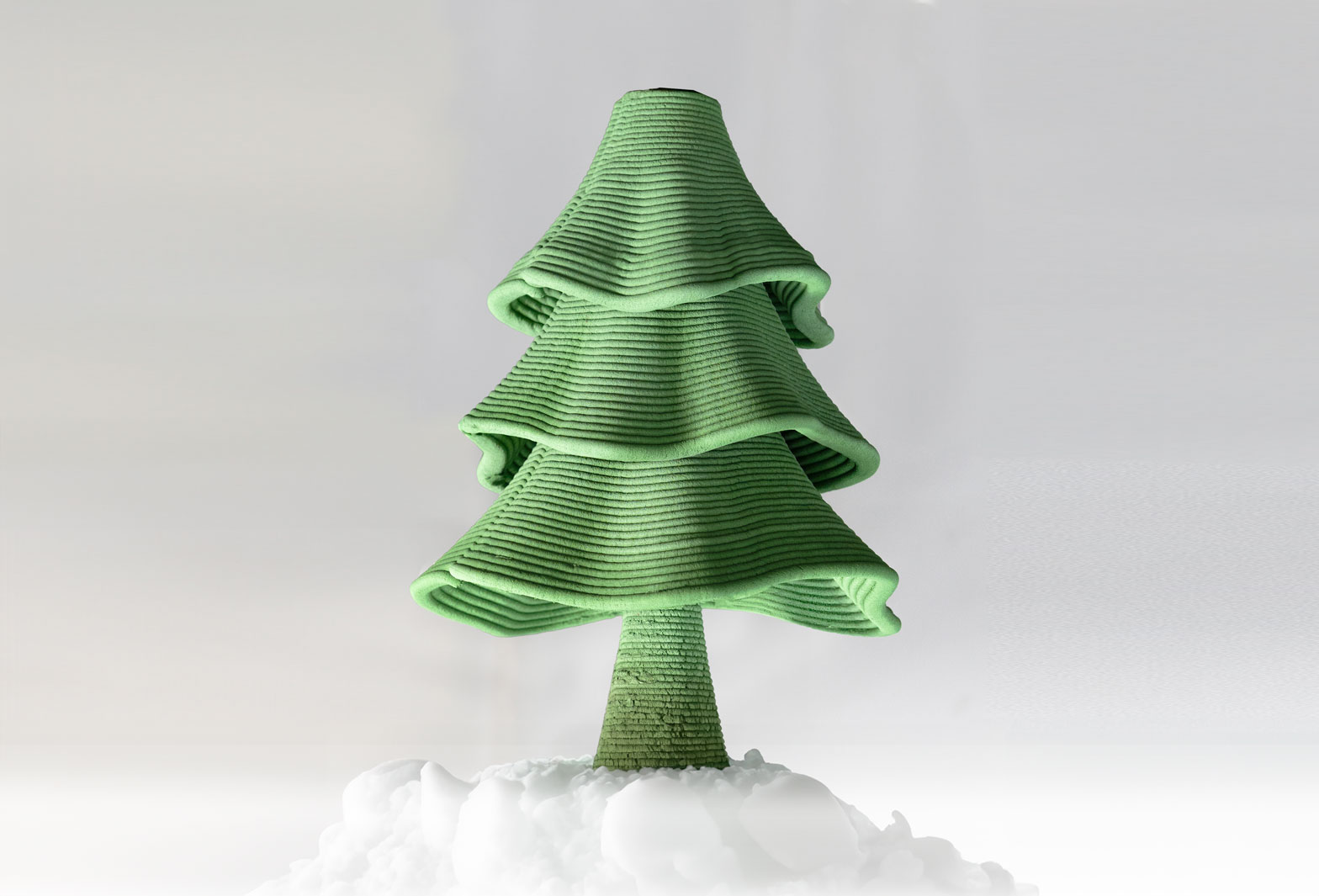 Green ribbed Christmas tree sculpture sitting on white textured base