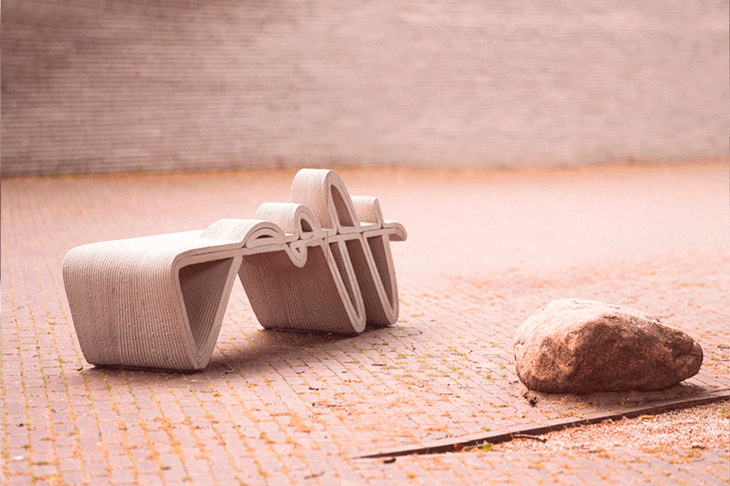 Wooden sculpture with curved form and rock on textured surface
