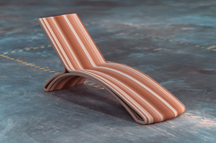 Curved wooden lounger with striped terracotta-colored design on blue surface