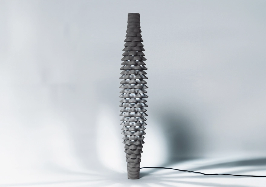Tall sculptural object with layered, wavy design on minimalist background