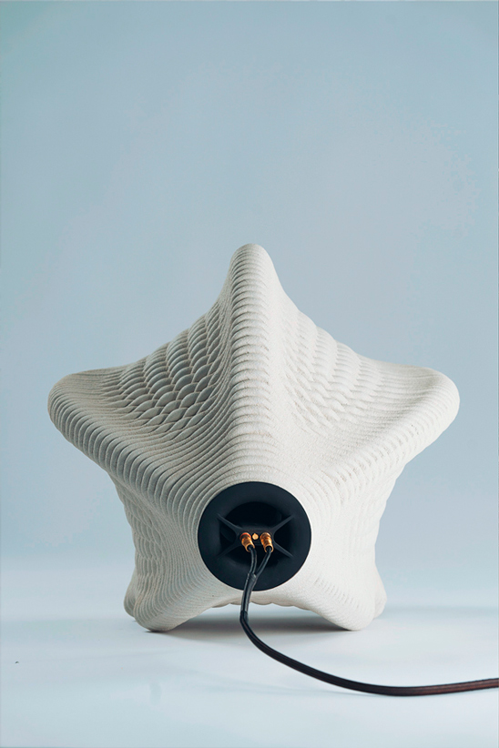 Star-shaped white ceramic object with electrical cord and socket