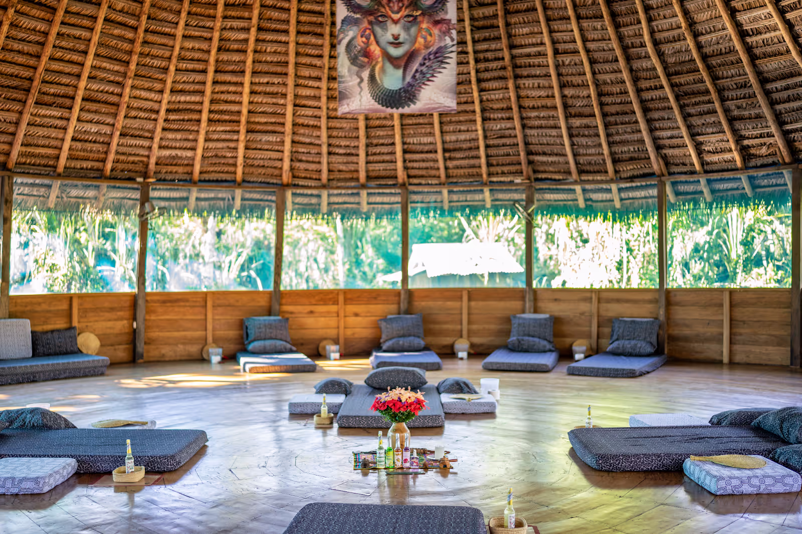 Arkana's round ceremony maloka by day, cushions arranged in a ring around the central altar