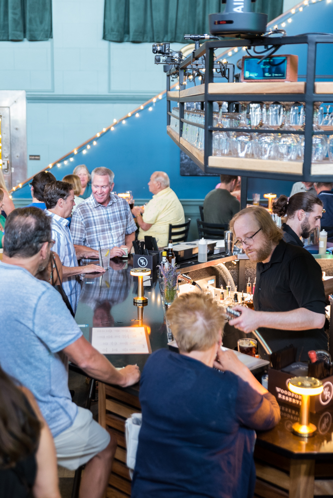 Guests gathered around the bar at The Caz