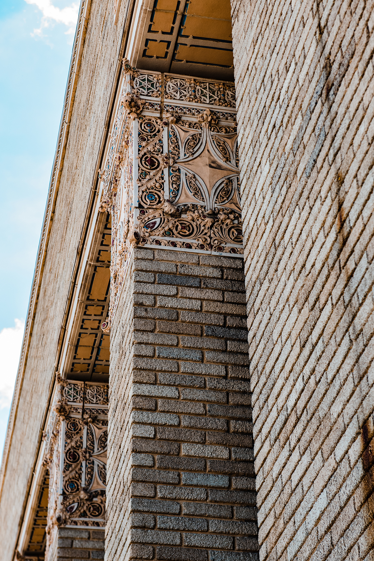 Looking up the brick exterior of The Caz at its decorative terra cotta details