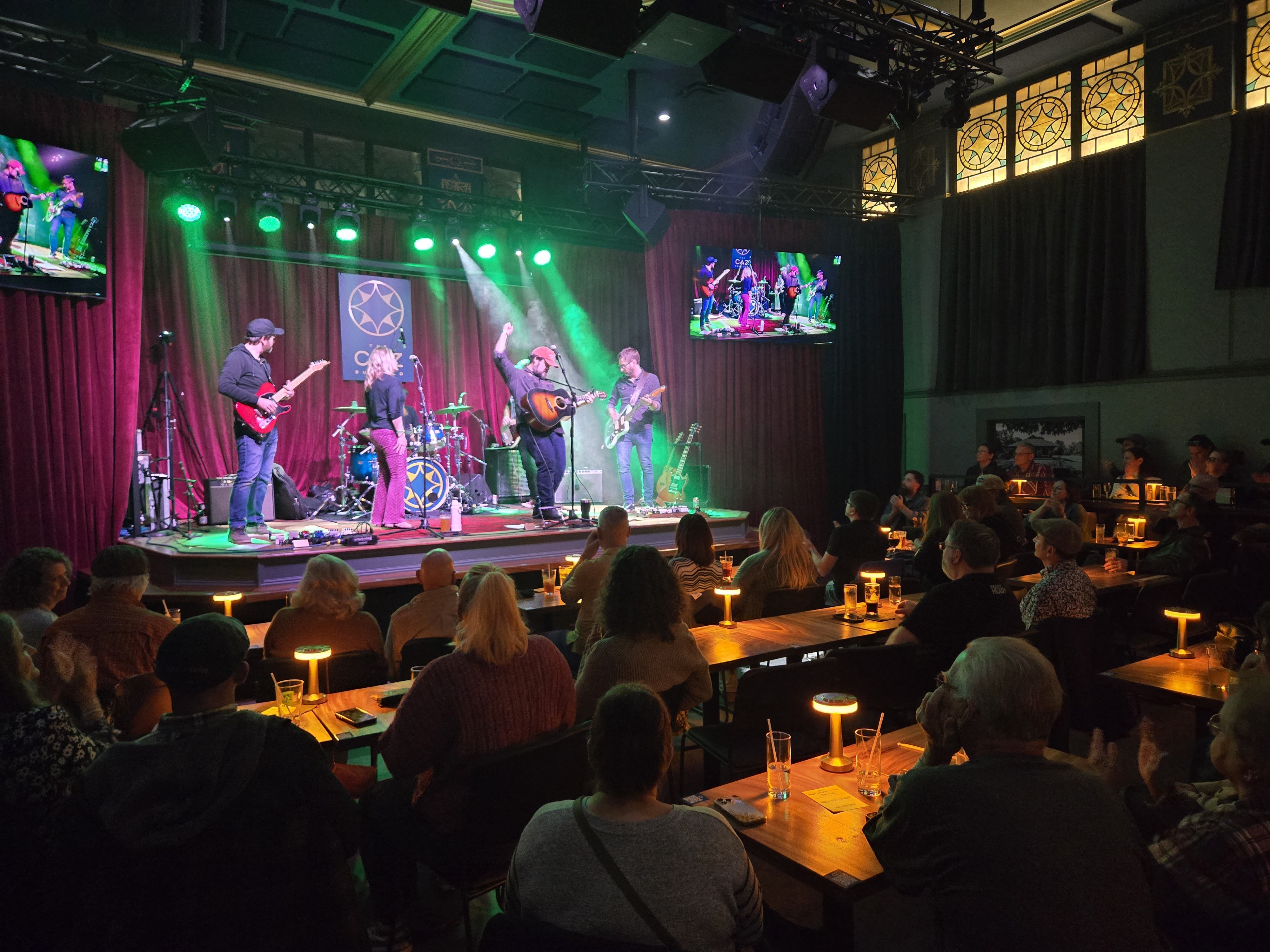 A band performing to a seated dinner crowd at The Caz