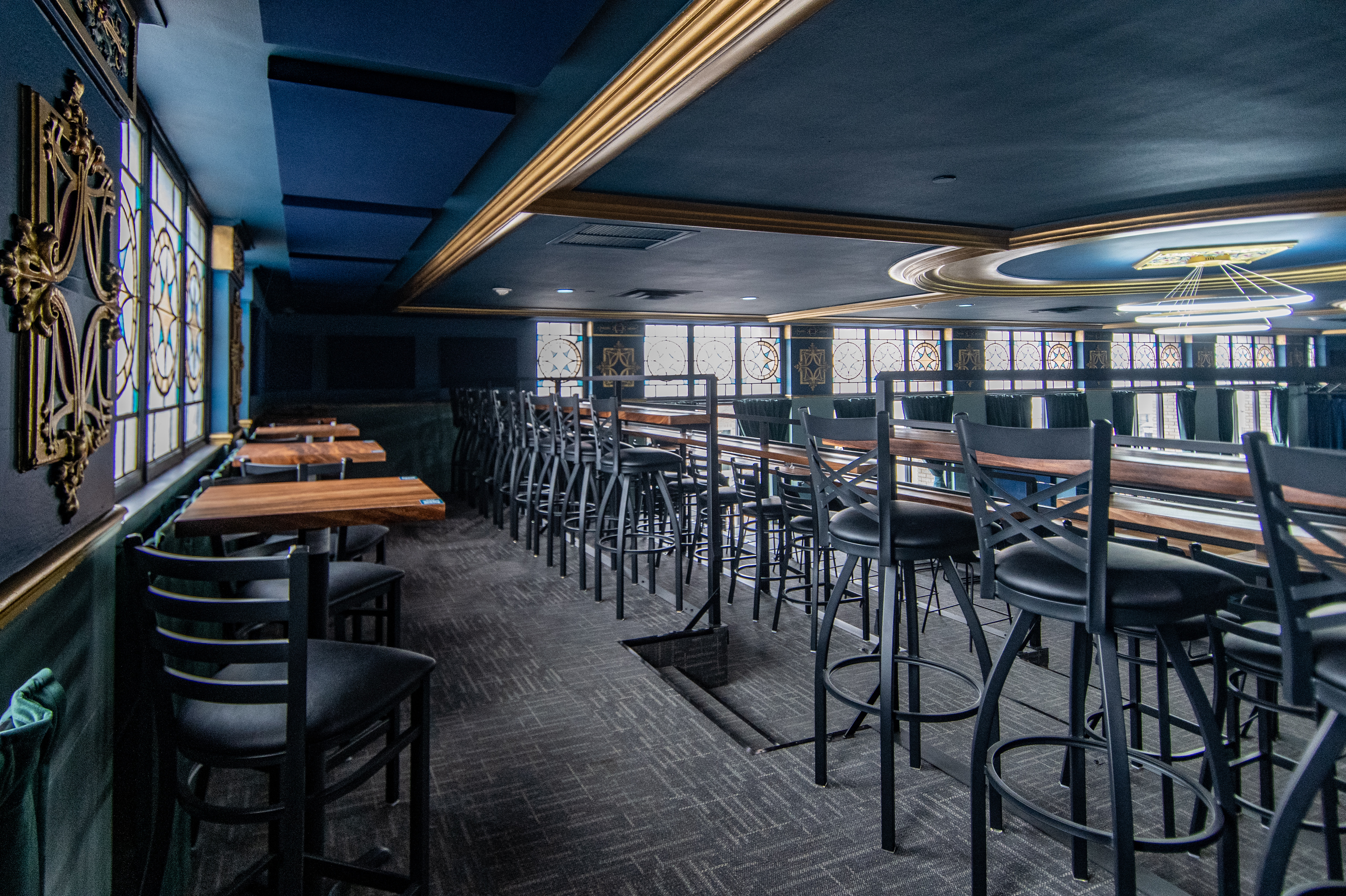 Mezzanine bar seating with high-top tables at The Caz