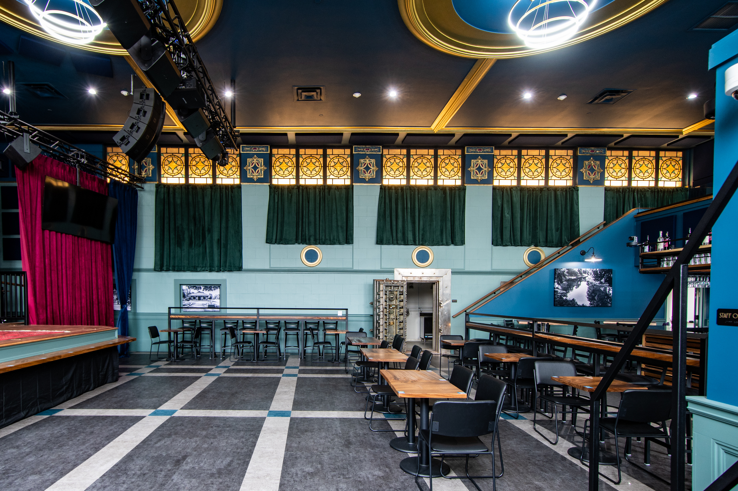 The Caz main floor with tables and seating facing the stage