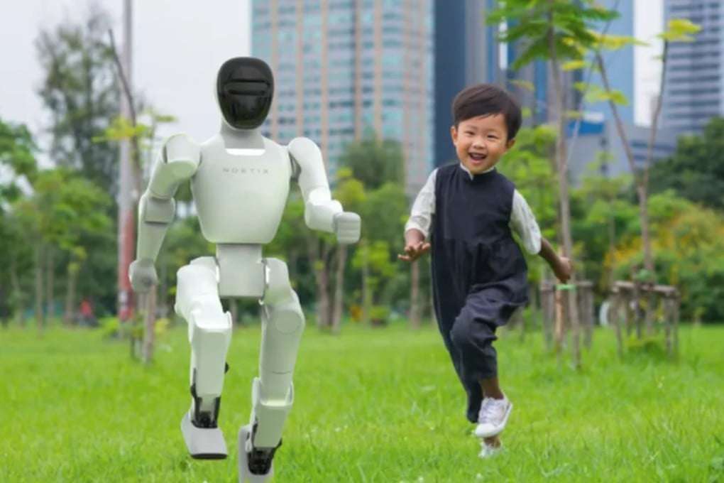 Noetix Bumi humanoid robot running alongside young child in outdoor park setting with city skyline background, demonstrating child-safe 94cm height approximately matching 4-5 year old child's stature, white and black humanoid form factor with smooth rounded limbs, both figures captured mid-stride showing Bumi's bipedal locomotion capability on grass terrain, illustrating family entertainment and educational companion use case for $1,370 consumer robot