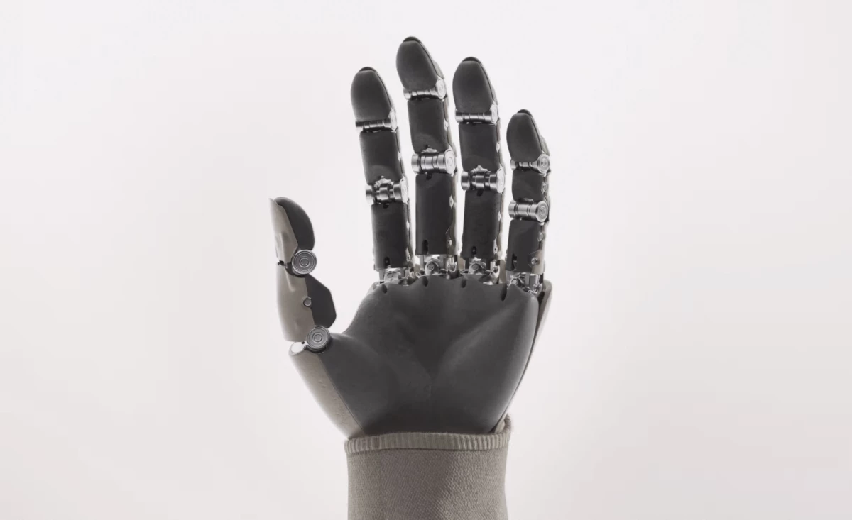 1X NEO humanoid robot hand close-up showing 22 degrees of freedom with individual finger articulation and tendon-driven actuation for human-level dexterity