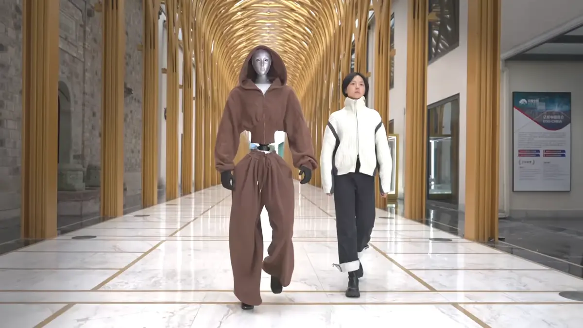 Unitree H2 humanoid robot walking alongside human model, demonstrating 182cm (6 foot) human-scale height for factory and service applications