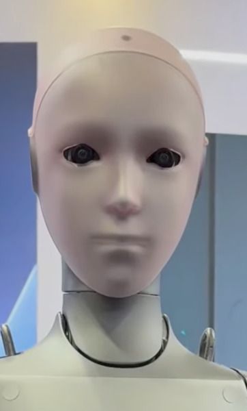 Unitree H2 bionic humanoid face close-up showing lifelike features, dual-eye camera system, and expressive design for human interaction