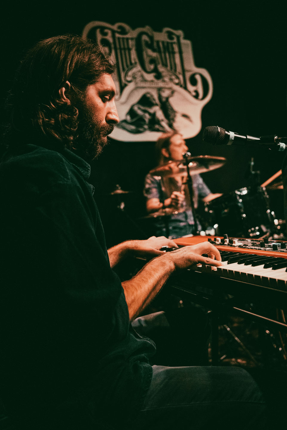 A keyboardist performing on stage at The Camel