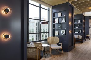 Interior design - Shelves with books flat against the wall displayed as artwork but ready to pick up and read.