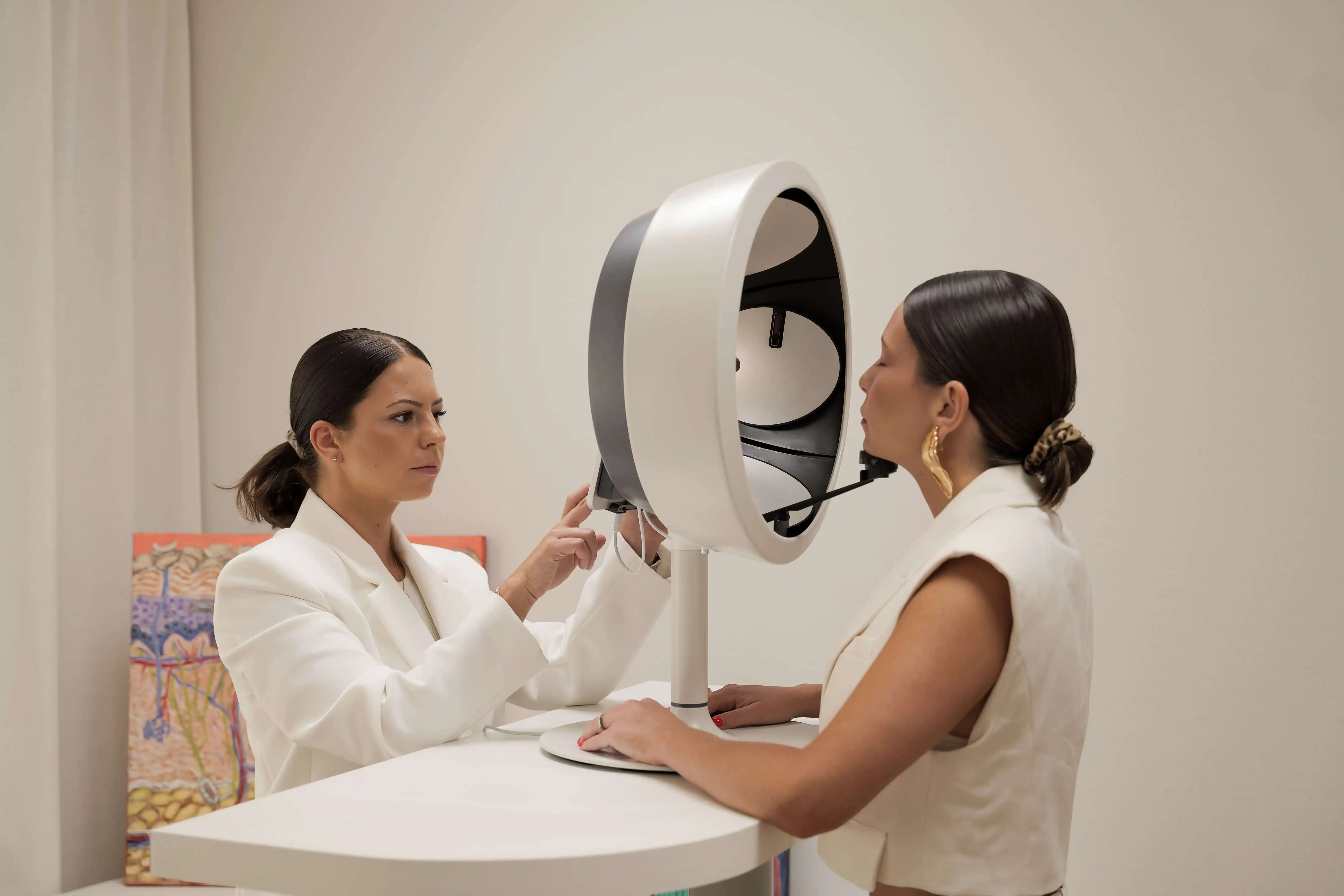 there are two women that are looking at a computer screen