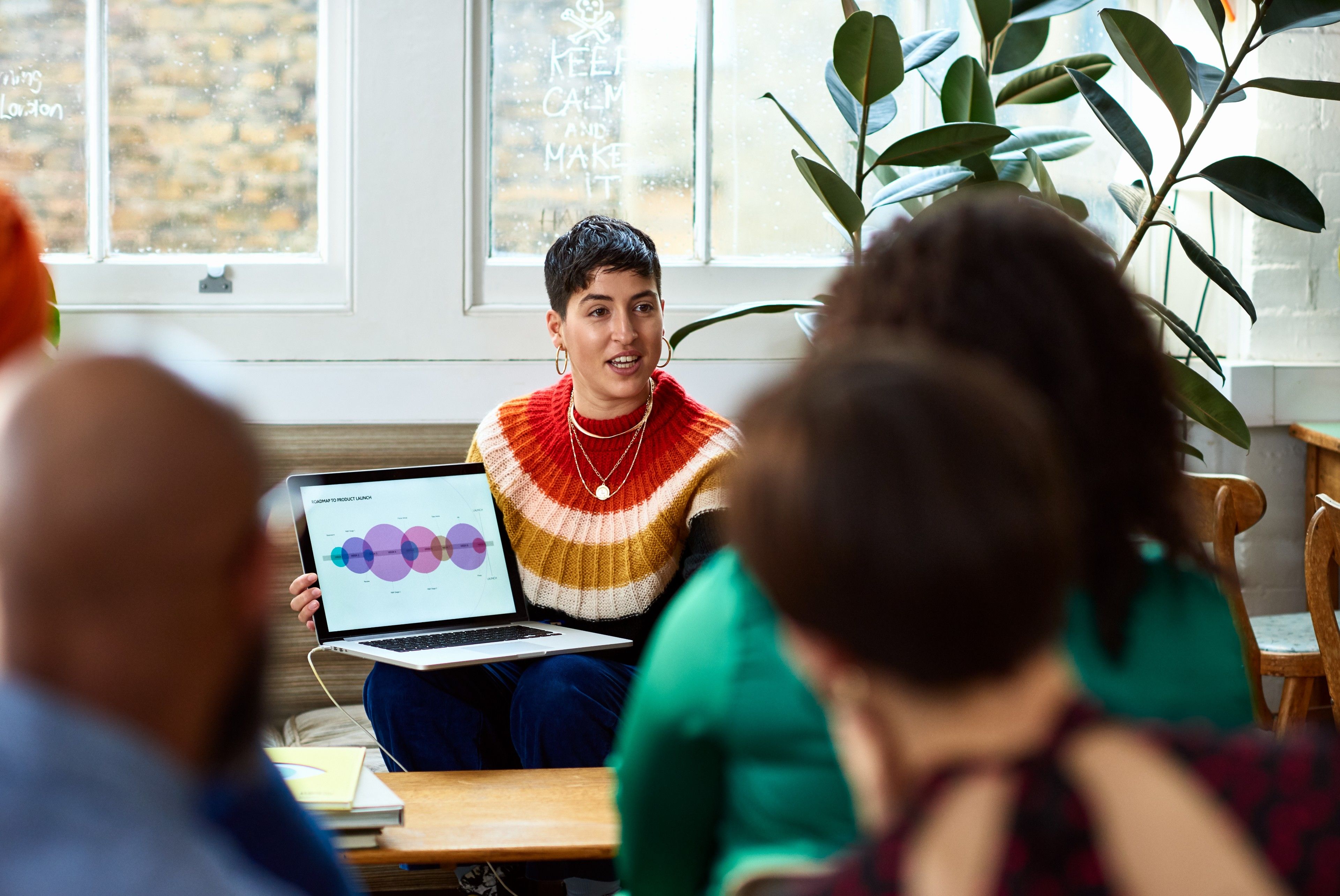 Creative team reviewing visual campaign data during a casual in-person presentation.