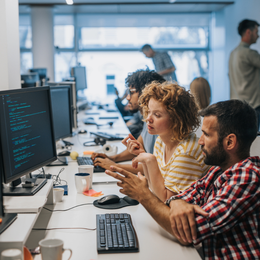 Creative team gathered around a table reviewing color palettes and visuals for a project launch.