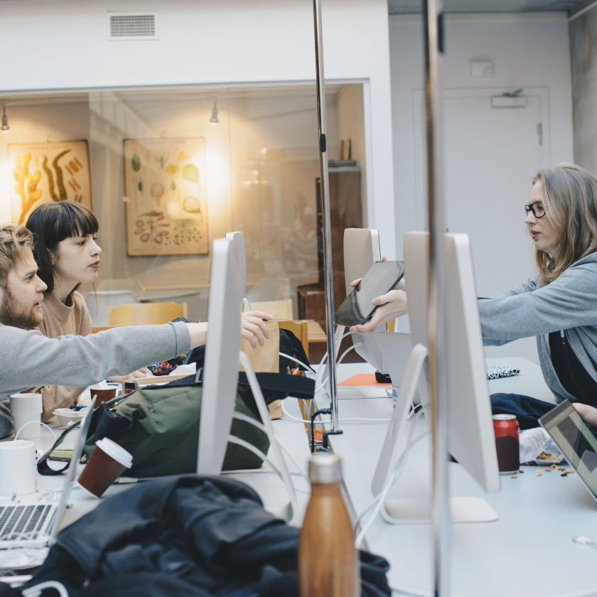 A group of colleagues share ideas in an office while brainstorming.