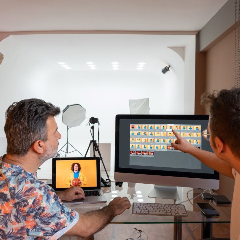 Creative team sorting through image assets in a studio environment.