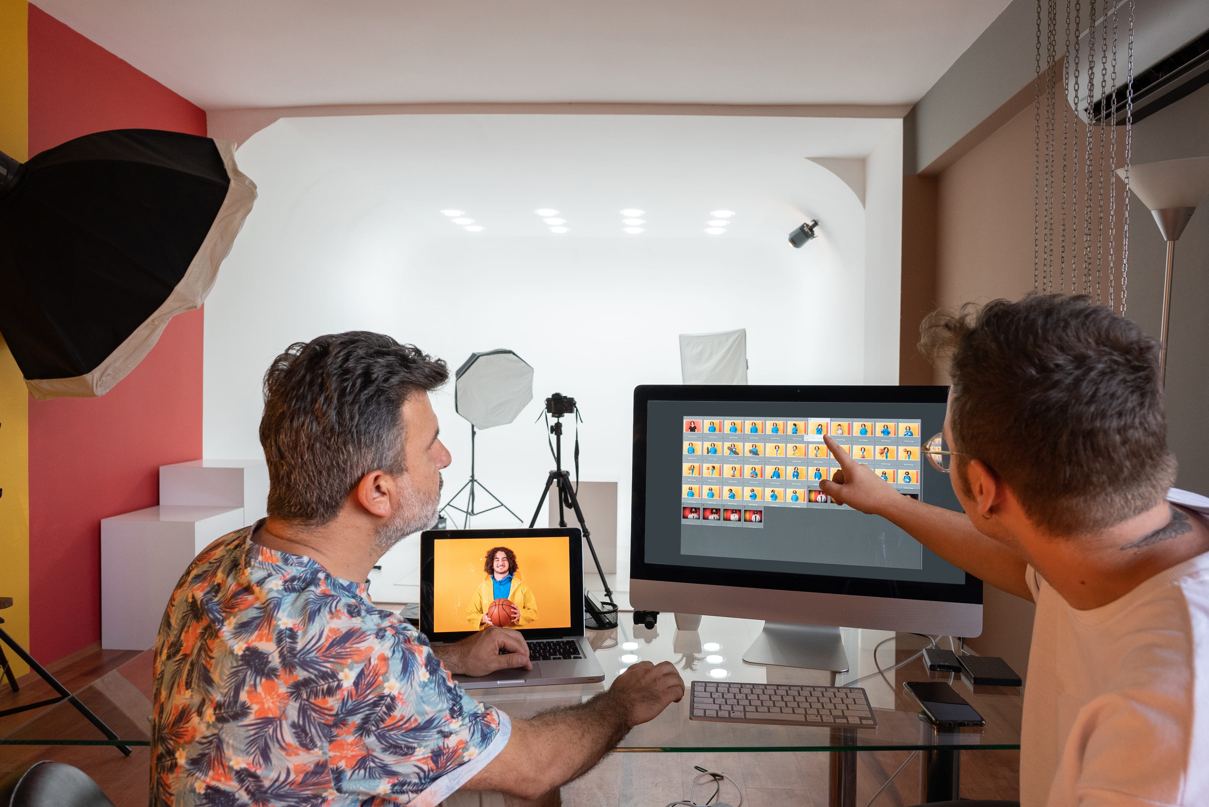 Photographers reviewing headshots on screen during a photo shoot workflow.