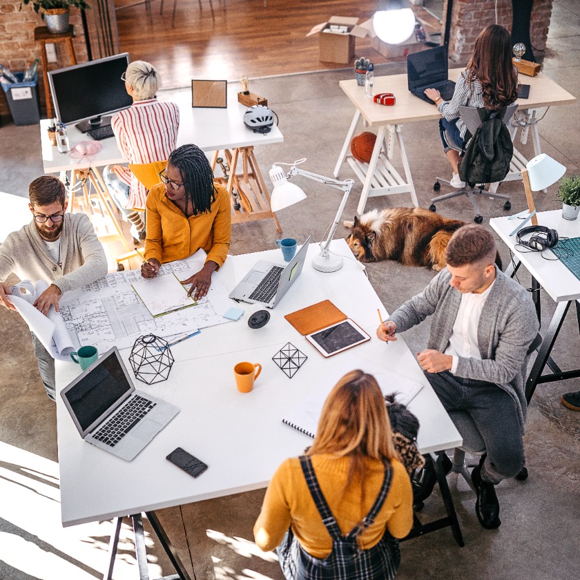 Designers and developers focused on individual projects in a shared workspace, suggesting fragmented team activity.