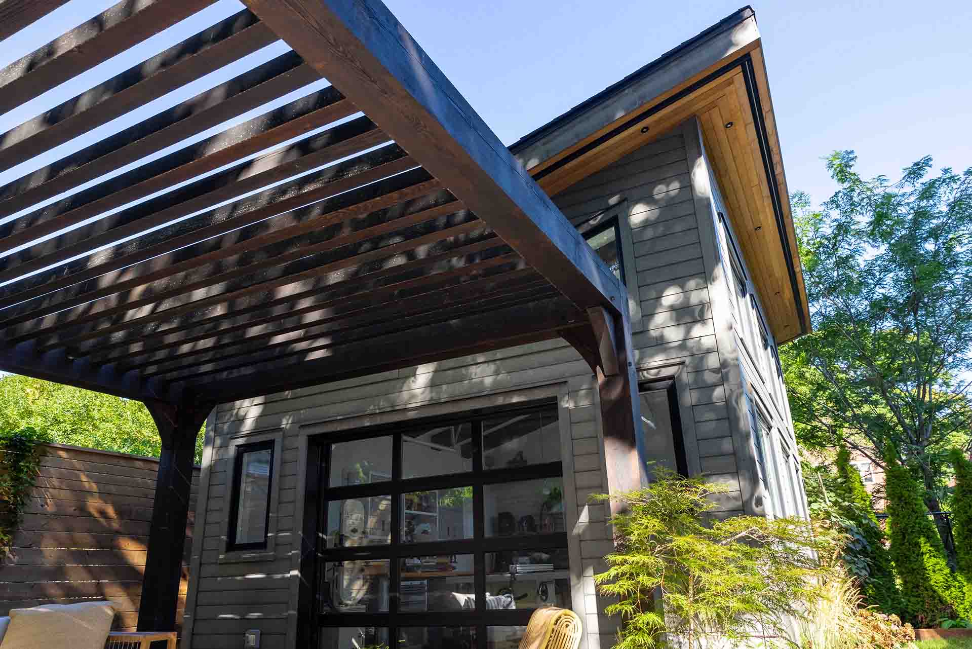 Backyard custom multi-purpose  two-storey shed used for entertaining, workout gym, studio, and bunkie house for guests to stay. 