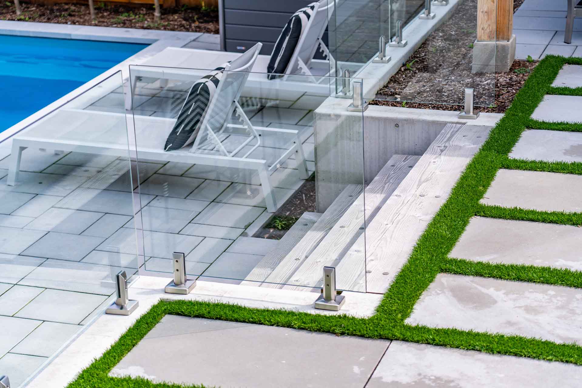 Custom in-ground swimming pool integrated with landscaped backyard.