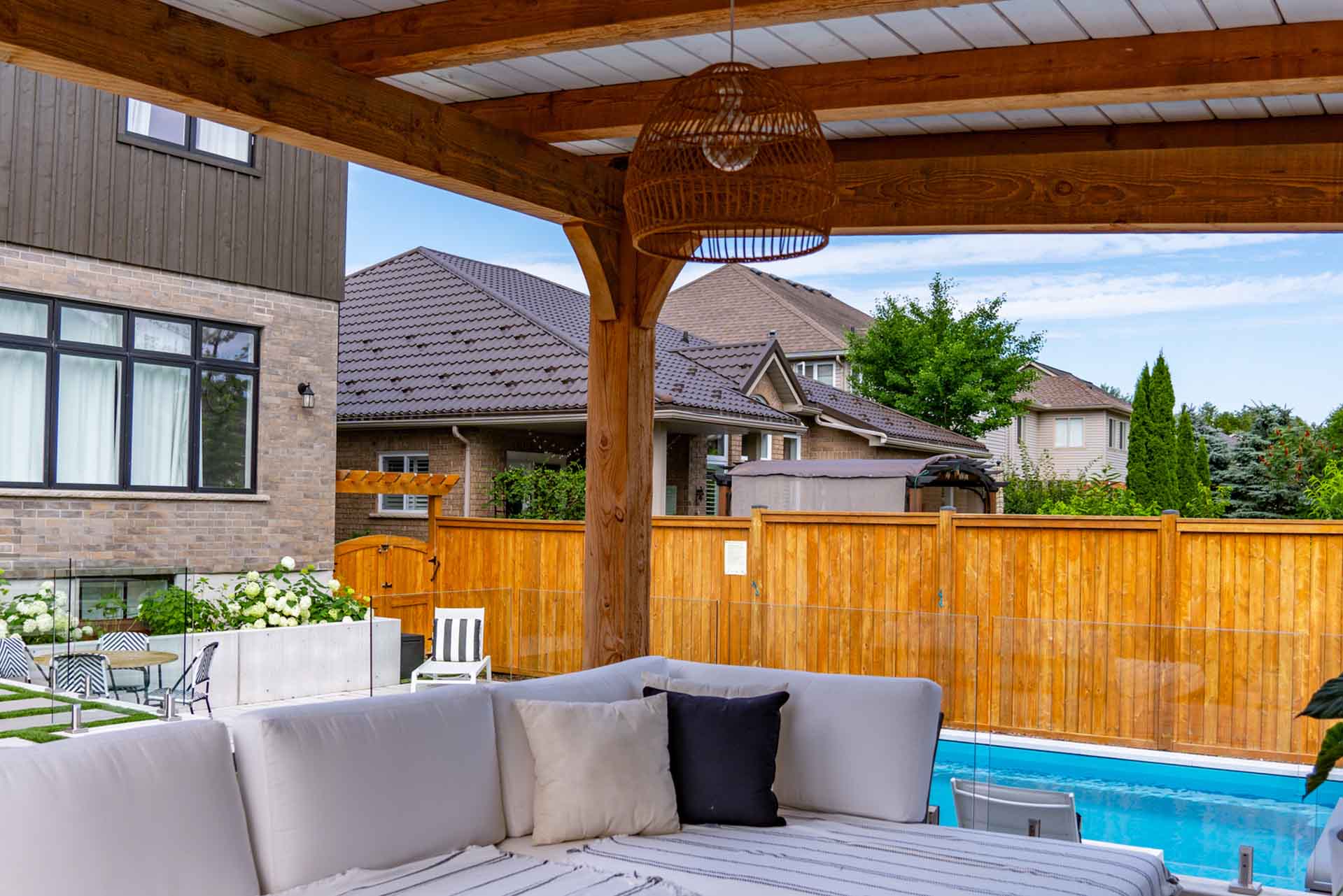 Custom in-ground swimming pool integrated with landscaped backyard.
