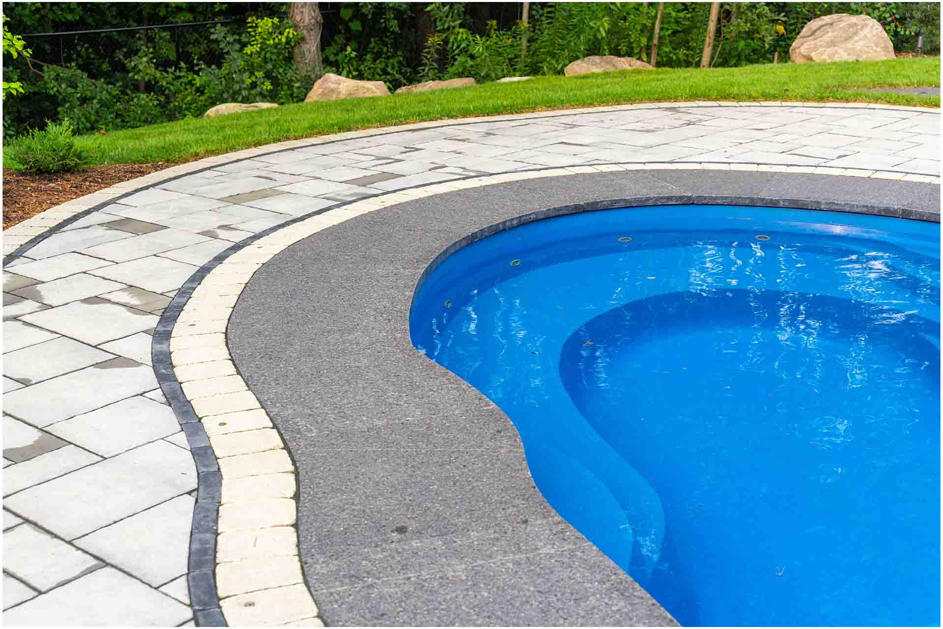 Luxury in-ground pool designed as part of a complete outdoor living space.