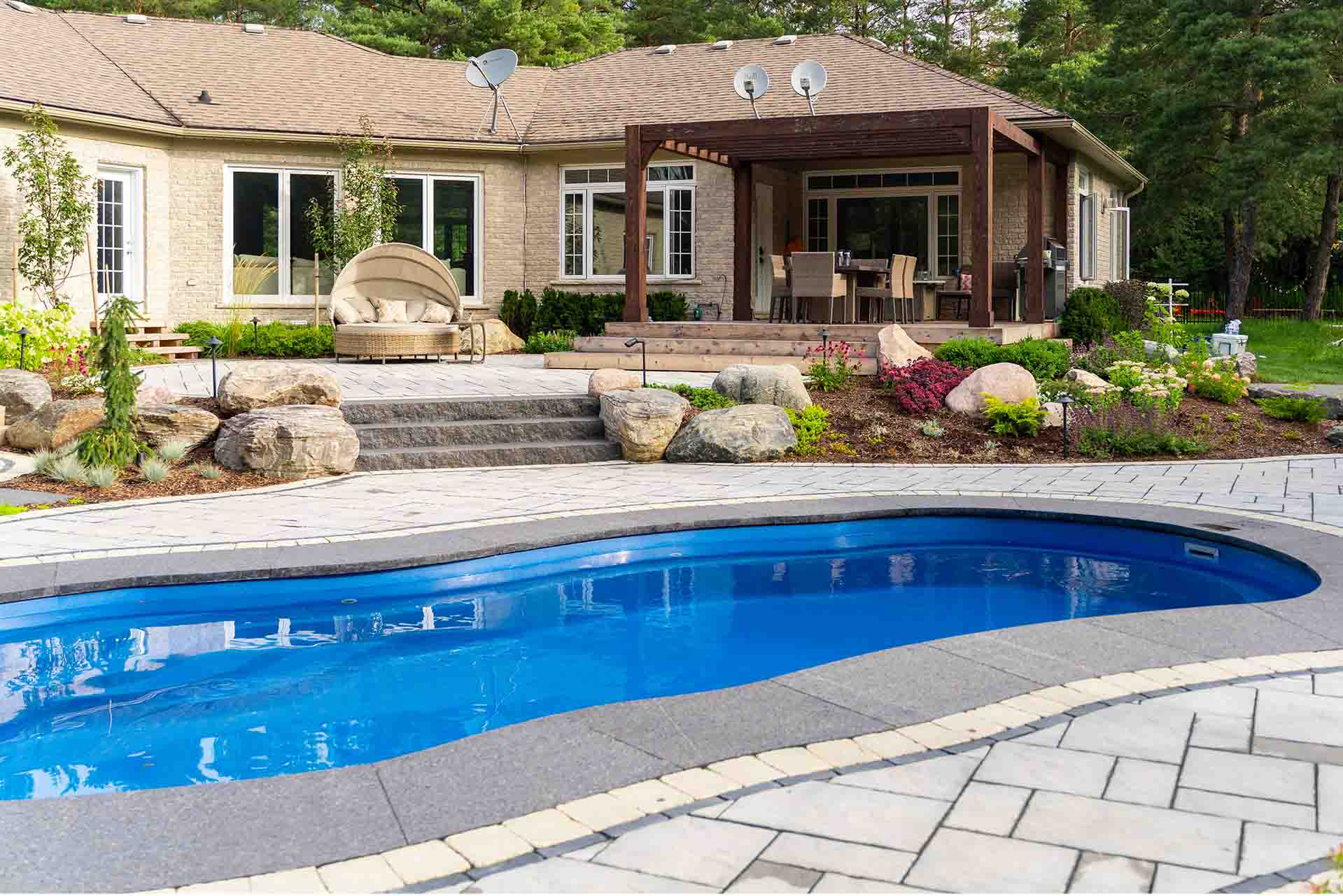 Luxury in-ground pool designed as part of a complete outdoor living space.
