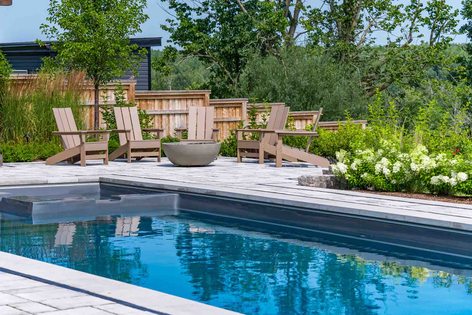 In-ground pool integrated with hardscape, planting, and outdoor amenities.