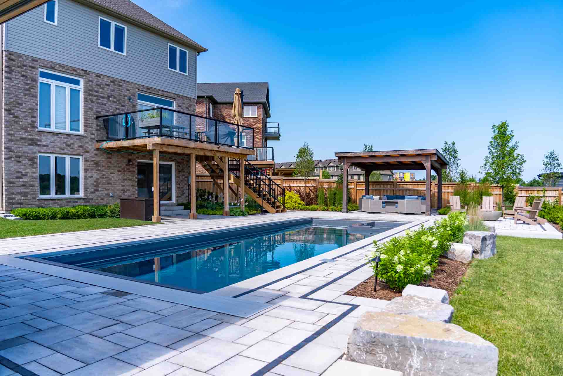 In-ground pool integrated with hardscape, planting, and outdoor amenities.