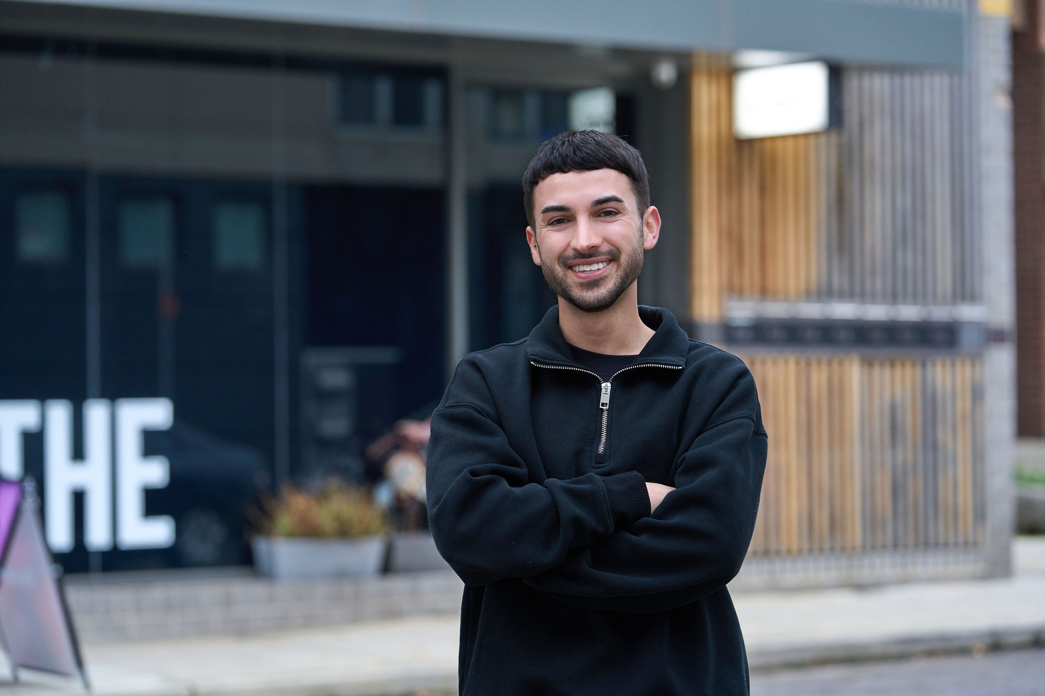 Adrian, a breathwork facilitator at No Name Studios smiling at the camera.