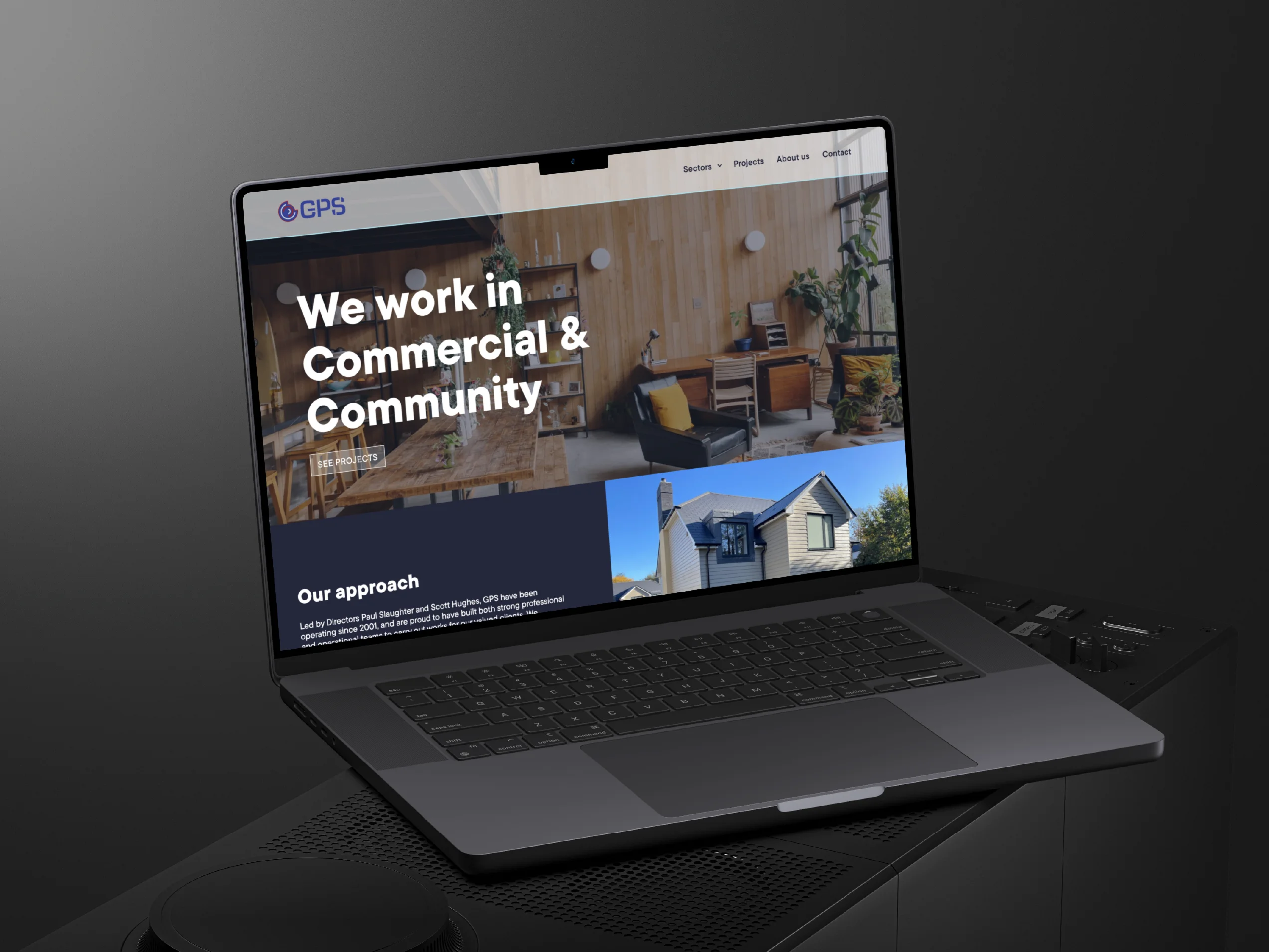 Laptop displaying a website for GPS with the text 'We work in Commercial & Community' over an office interior and a house exterior photo.