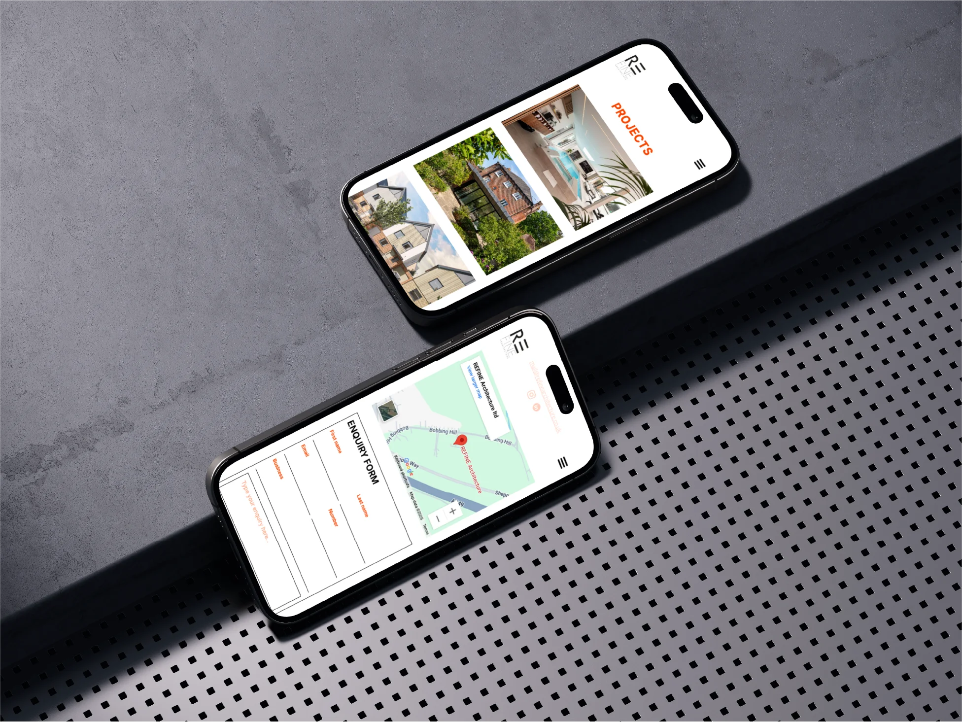 Two smartphones on a gray surface showing a project gallery with house images and an enquiry form with a map on their screens.