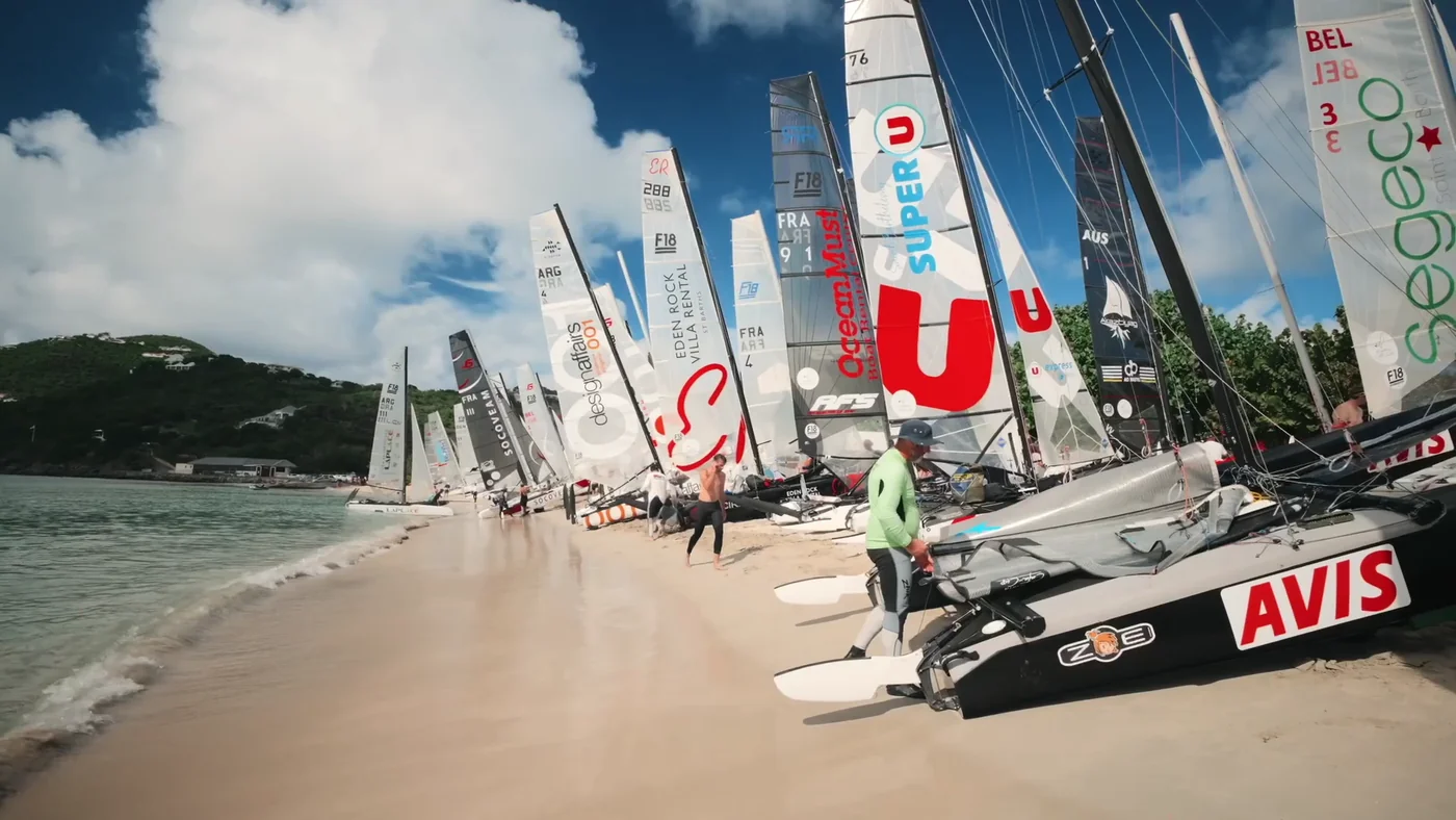 Catamarans lined up on the beach before racing