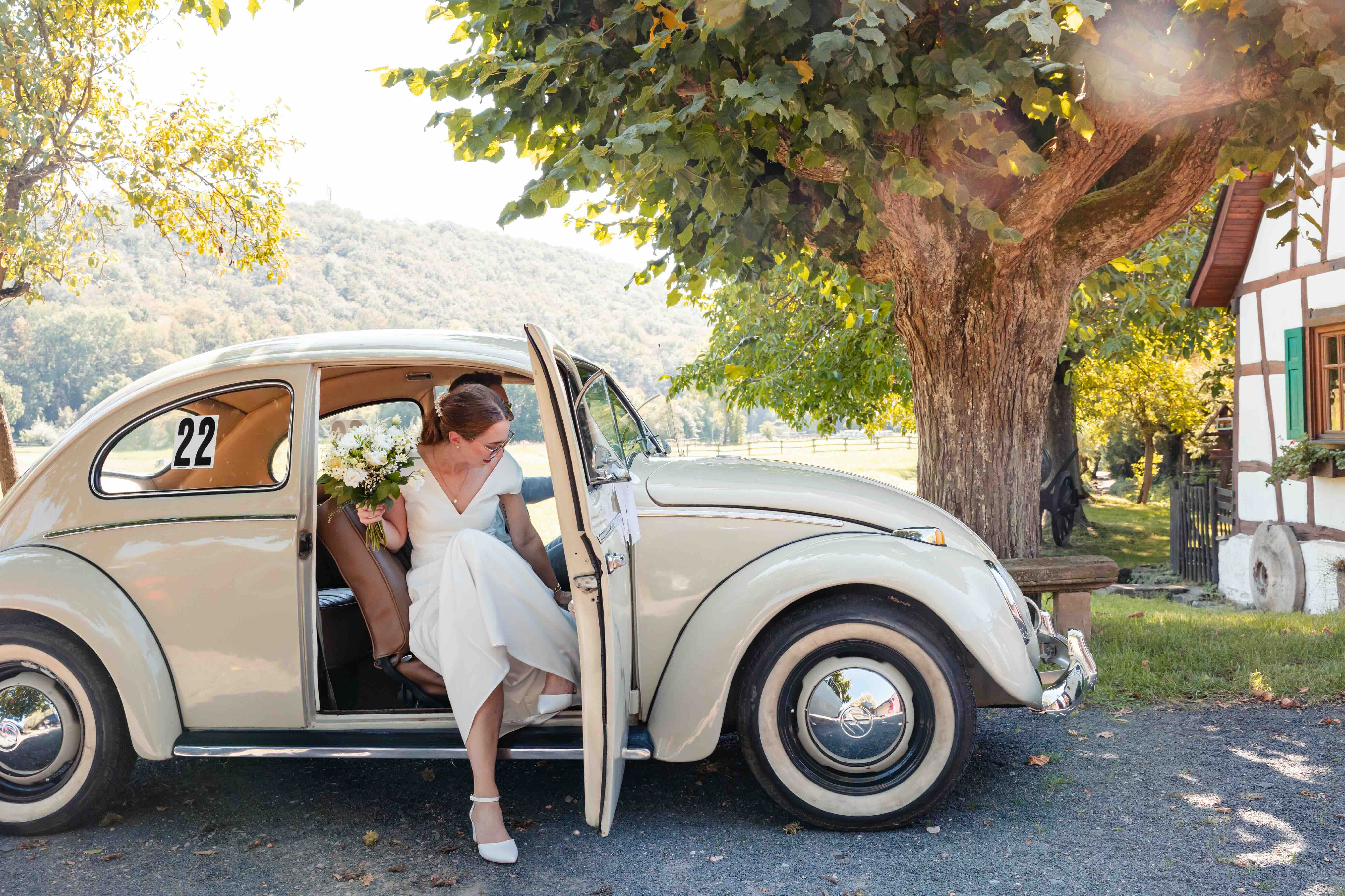 bride getting out of a car with her bouquet in hand