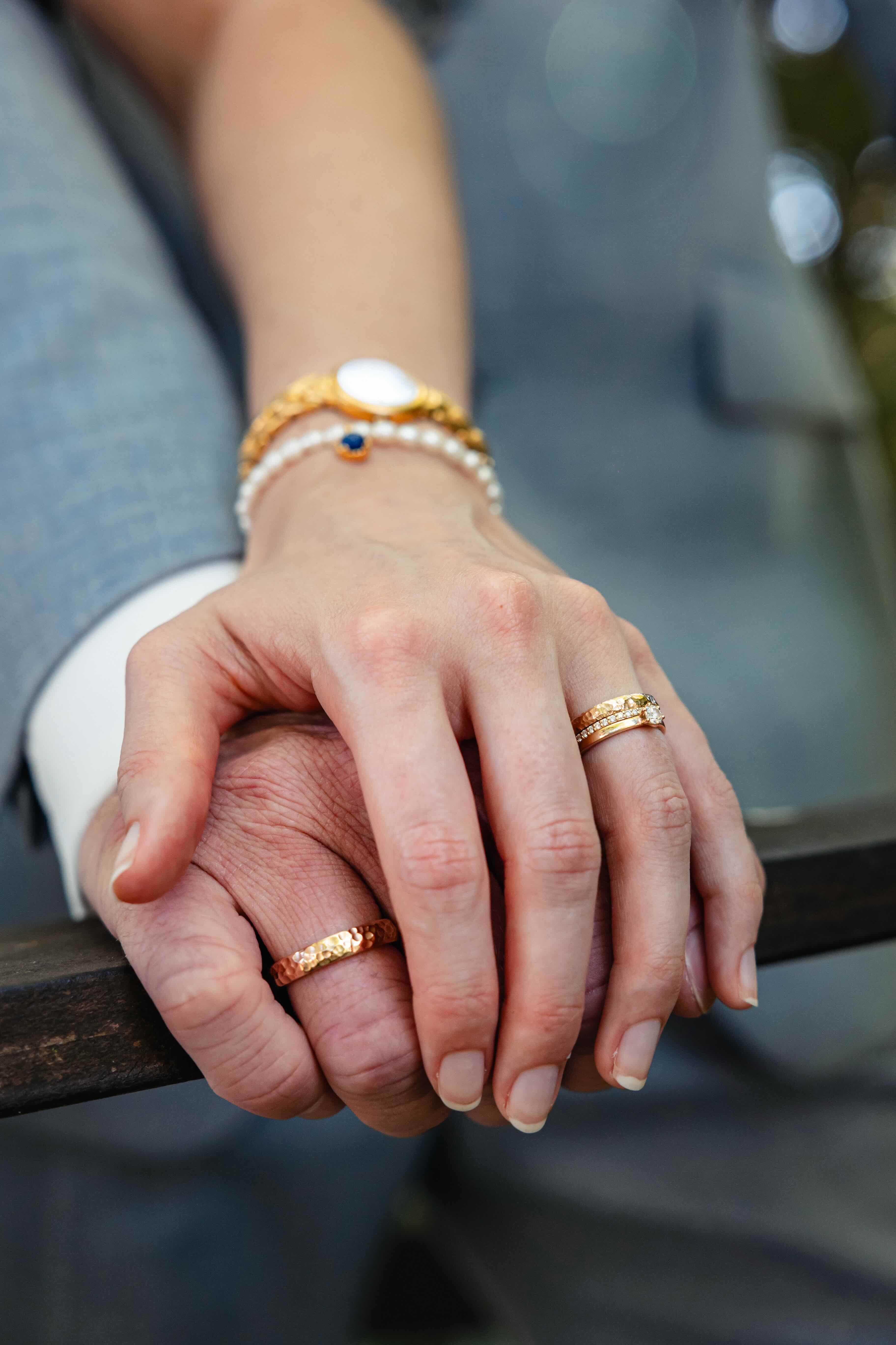 there are two hands holding each other on a bench